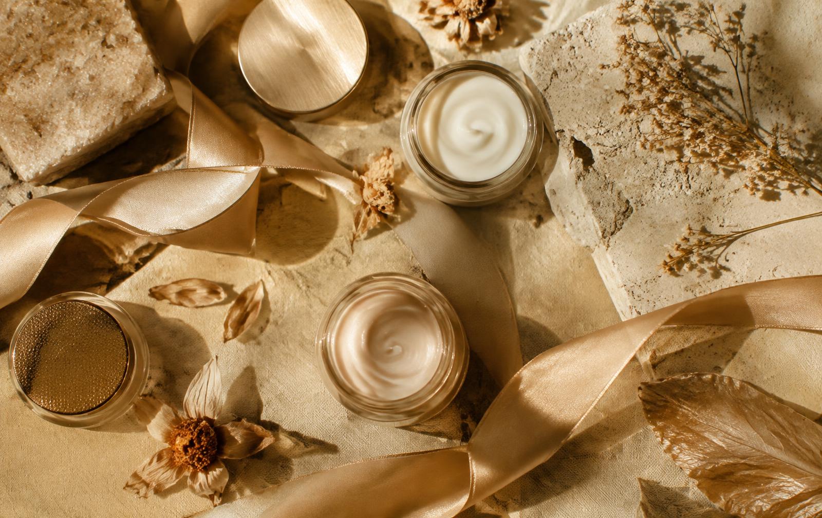 Luxury skincare jars with dried botanicals and silk ribbon